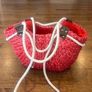 Light/faded red straw bag